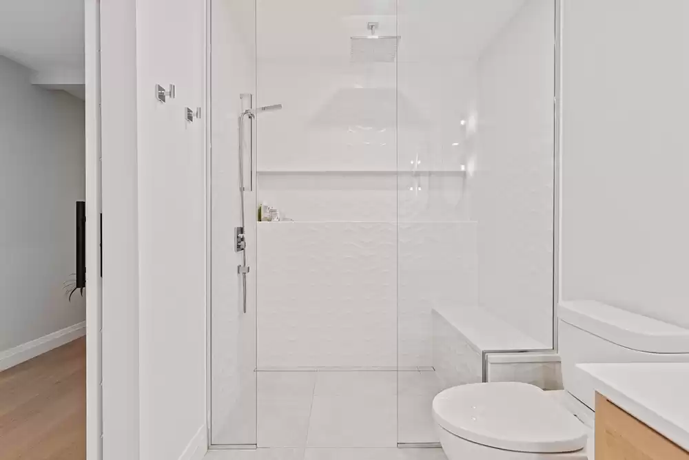A small and simple shower with a glass door