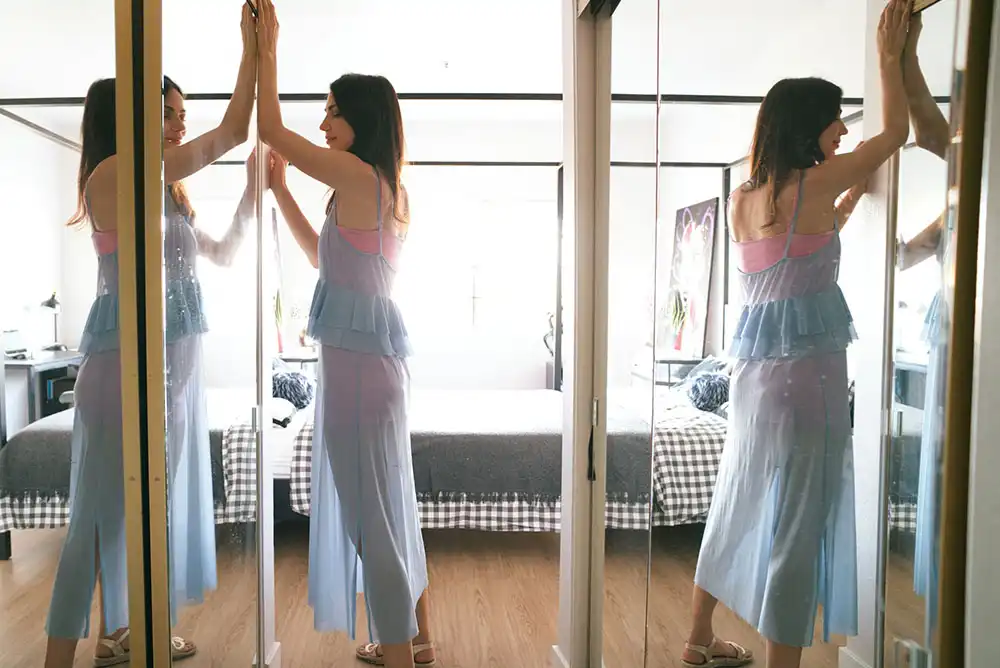a woman installing a sliding mirror closet door