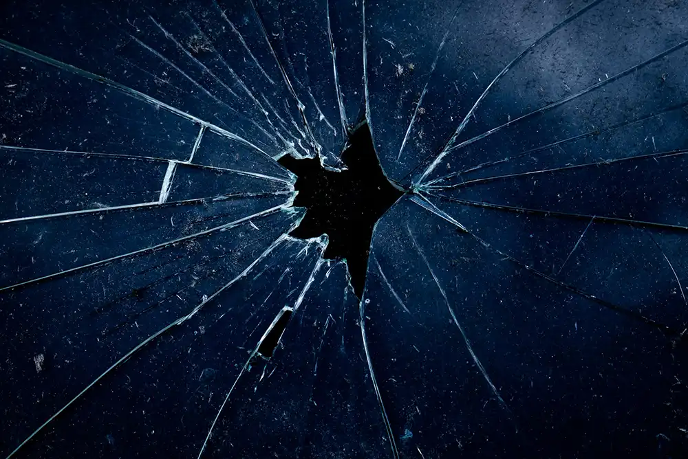 A close-up of cracked and broken glass.