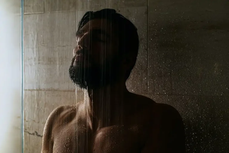 Removing Soap Scum From a Block Shower Wall | Community Glass and Mirror A man taking a shower